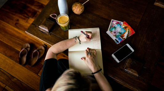 Woman writing on a notepad 