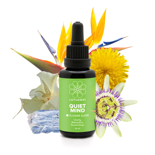 LOTUSWEI Quiet Mind Flower Elixir bottle backed by bird of paradise, dandelion, passionflower, brugmansia, and kyanite